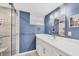 Stylish bathroom with a modern vanity, framed mirror and glass-enclosed shower at 4350 Chatham Dr # 208, Longboat Key, FL 34228