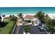 Beachfront property featuring lush landscaping, ample parking, and a charming beachside building at 4350 Chatham Dr # 208, Longboat Key, FL 34228