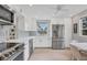 Well-lit kitchen featuring stainless steel appliances, white cabinetry, and modern countertops for a sleek cooking space at 4350 Chatham Dr # 208, Longboat Key, FL 34228