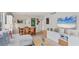 Bright living room featuring wood floors, modern decor, and a large TV for comfortable entertaining and relaxation at 4350 Chatham Dr # 208, Longboat Key, FL 34228