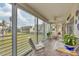 Enclosed patio with seating area and lovely views of the surrounding community and lush greenery at 4350 Chatham Dr # 208, Longboat Key, FL 34228
