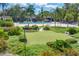 Beautiful pool area with lounge chairs, complemented by lush landscaping and a putting green at 4350 Chatham Dr # 208, Longboat Key, FL 34228