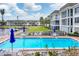 Inviting community pool surrounded by lush landscaping and scenic waterfront views on a sunny day at 4350 Chatham Dr # 208, Longboat Key, FL 34228