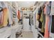 Spacious walk-in closet with custom shelving, drawers, and ample storage for clothes and personal items at 4350 Chatham Dr # 208, Longboat Key, FL 34228