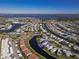 Aerial view of the community and its winding canals with nearby golf courses and community features at 4714 Potomac Cir, Bradenton, FL 34210