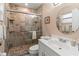 Bathroom with tiled shower, glass door, and white vanity for a clean and modern look at 4714 Potomac Cir, Bradenton, FL 34210