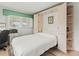 Cozy bedroom featuring a murphy bed, built-in cabinets, and a window letting in natural light at 4714 Potomac Cir, Bradenton, FL 34210
