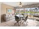 Cozy dining area with lake view, featuring a glass table and comfortable seating at 4714 Potomac Cir, Bradenton, FL 34210