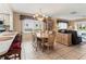 Open dining room with natural light, chandelier, and neutral tile floors flowing into the living area at 4714 Potomac Cir, Bradenton, FL 34210