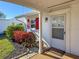 Inviting front entrance with decorative plants and a glass storm door at 4714 Potomac Cir, Bradenton, FL 34210