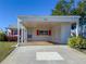 Charming home featuring a covered carport, with lots of storage and well-maintained front yard at 4714 Potomac Cir, Bradenton, FL 34210