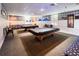 Spacious game room with billiard tables under bright lighting, accented by nautical-themed decor and cozy seating at 4714 Potomac Cir, Bradenton, FL 34210