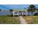 Scenic lakeside gazebo with seating, perfect for enjoying waterfront views and relaxation at 4714 Potomac Cir, Bradenton, FL 34210