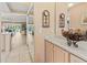 Bright hallway with tile floors, leading to a living area with neutral paint and ample natural light at 4714 Potomac Cir, Bradenton, FL 34210