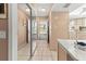 Neutral hallway featuring tile floors, mirrored closets, and leading to the kitchen and exterior at 4714 Potomac Cir, Bradenton, FL 34210