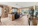 Inviting living room features neutral tile flooring, comfortable furniture, and bright windows with a view at 4714 Potomac Cir, Bradenton, FL 34210