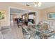 Open-concept living room with a glass table, comfortable seating, and views to the kitchen area at 4714 Potomac Cir, Bradenton, FL 34210