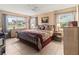 Serene main bedroom featuring tile flooring, natural light, and comfortable furnishings at 4714 Potomac Cir, Bradenton, FL 34210