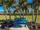 Enjoy seating on a park bench under the palm trees, enhanced by landscaping at 4714 Potomac Cir, Bradenton, FL 34210