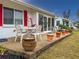 Relaxing backyard patio with outdoor seating and decorative flower pots; vibrant red shutters at 4714 Potomac Cir, Bradenton, FL 34210
