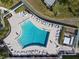 Aerial view of a community pool with lounge chairs, tables, and a meticulously maintained pool area at 4714 Potomac Cir, Bradenton, FL 34210