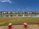 Water view from the patio with colorful flower pots on a clear sunny day at 4714 Potomac Cir, Bradenton, FL 34210