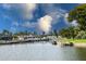 Picturesque waterfront view featuring private docks, lush landscaping, and multiple boats along the canal at 4714 Potomac Cir, Bradenton, FL 34210