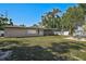 A large backyard with a screened patio attached to the house and a backyard firepit at 5445 Bahia Vista St, Sarasota, FL 34232