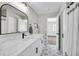 Renovated bathroom featuring marble countertops, decorative tile flooring, and modern fixtures at 5445 Bahia Vista St, Sarasota, FL 34232