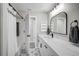 Updated bathroom featuring a marble countertop vanity, modern fixtures, and a shower with tiled accents at 5445 Bahia Vista St, Sarasota, FL 34232