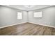 Inviting bedroom with wood-look floors, neutral walls, and large windows offering plenty of natural light at 5445 Bahia Vista St, Sarasota, FL 34232