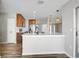 Open kitchen with island, stainless appliances, wood cabinets, and pendant lighting fixtures at 5445 Bahia Vista St, Sarasota, FL 34232