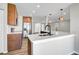 Open-concept kitchen with stainless steel appliances, a large island, and modern pendant lighting at 5445 Bahia Vista St, Sarasota, FL 34232