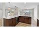 Bright, modern kitchen with wood cabinets, white counters, and a view to the outdoor space at 5445 Bahia Vista St, Sarasota, FL 34232