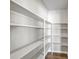 Walk-in pantry with ample shelving and laminate flooring, providing excellent storage space at 5445 Bahia Vista St, Sarasota, FL 34232