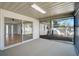 An outdoor screened patio leads inside with large sliding doors and overlooks the well-kept garden at 5445 Bahia Vista St, Sarasota, FL 34232