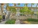 Charming two-story condo with a private entrance, mature trees and inviting curb appeal at 6750 Gulf Of Mexico Dr # 153, Longboat Key, FL 34228