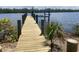 New dock with a boat lift overlooking the calm water at 777 N Manasota Key Rd, Englewood, FL 34223