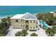 Stunning beach house with a metal roof, pool, palm trees, and beautiful beach at 777 N Manasota Key Rd, Englewood, FL 34223