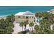 Stunning beach house with a metal roof, a pool, palm trees, and beautiful beach access at 777 N Manasota Key Rd, Englewood, FL 34223