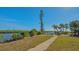 Brick path leading to water views and lush landscaping at 777 N Manasota Key Rd, Englewood, FL 34223