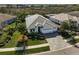 Aerial view of a well-maintained single-Gathering home with a gray roof, desert landscaping, and spacious backyard at 8261 Grande Shores Dr, Sarasota, FL 34240