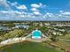 The aerial view showcases a community pool overlooking the serene lake at 8261 Grande Shores Dr, Sarasota, FL 34240