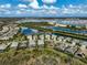 This aerial view shows homes situated along a waterfront, offering scenic views and access to water activities at 8261 Grande Shores Dr, Sarasota, FL 34240