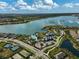 This aerial view shows a pool and lake surrounded by luxurious amenities and well-maintained landscaping at 8261 Grande Shores Dr, Sarasota, FL 34240