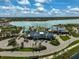 Beautiful aerial view of community center, pool, and serene lake in Lakehouse Cove at Waterside at 8261 Grande Shores Dr, Sarasota, FL 34240