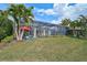 This home features a screened lanai overlooking the lush backyard, providing a serene outdoor living space at 8261 Grande Shores Dr, Sarasota, FL 34240