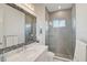 Stylish bathroom featuring a decorative mirror, marble countertop, and glass enclosed shower at 8261 Grande Shores Dr, Sarasota, FL 34240