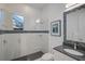 Modern bathroom with a glass-enclosed shower, granite countertop, and mosaic tile accents at 8261 Grande Shores Dr, Sarasota, FL 34240