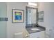 Elegant bathroom featuring granite countertops, a mosaic-tiled mirror, and a walk-in shower at 8261 Grande Shores Dr, Sarasota, FL 34240
